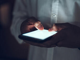 person using smartphone in the dark